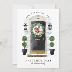 a holiday card with an image of a couple on the front door