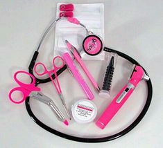 pink scissors and other items are arranged on a white surface