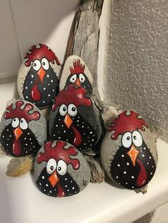 several painted rocks with cartoon birds on them