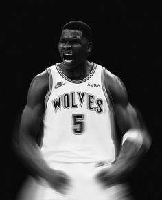 a black and white photo of a basketball player with his hands in the air while laughing