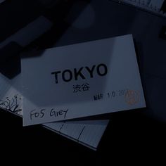 three pieces of paper with the word tokyo written on them sitting next to each other