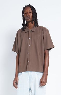 Keep things classy this season with the Ribbed Woven Button Down Shirt from PacSun. This shirt features a button-down front closure, a collared neckline, short sleeves, and a boxy, relaxed fit. 


	Button-down front closure
	Collared neckline
	Short sleeves
	Boxy fit
	PacSun branding
	Model is wearing a medium
	Model Measurements: 6'2” Height, 28" Waist, 34” Inseam Refer A Friend, Pacsun Mens, My Mobile Number, Brown Shirt, Pacsun, Model Measurements, Exclusive Collection, Button Downs, Cool Style