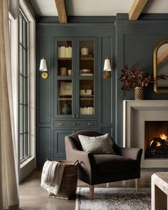 a living room filled with furniture and a fire place next to a window in front of a fireplace