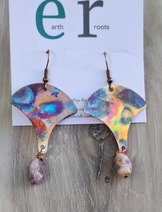 These boho shaped earrings feature fan shaped copper blanks that have been fire painted using a propane torch to bring out the different colors in the metal when heated.   NOTE:  Certain lighting will make the colors pop more than other types of lighting. They are finished with lepidolite gemstone bead dangles. These earrings will ship in a gift box via USPS with tracking info provided. Nickel-free Copper Artsy Jewelry, Artsy Nickel-free Copper Jewelry, Artsy Copper Drop Earrings, Unique Hand Painted Copper Jewelry, Unique Hand-painted Copper Jewelry, Bohemian Hand Painted Copper Jewelry, Bohemian Hand-painted Copper Jewelry, Artsy Copper Dangle Earrings, Artsy Nickel-free Copper Earrings