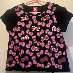 Hello Kittle Short Sleeve Little Girls Graphic Tee Size Medium 7/8 Ruffle At Bottom Graphics On Front, Solid Black On Back New With Tags Kawaii Black Top With Character Print, Black Kawaii Top With Character Print, Black Character Print Top For School, Black Hello Kitty Print Short Sleeve Top, Playful Black Tops For School, Kawaii Short Sleeve Tops For School, Cute Black Tops For School, Black Cotton Kawaii Top, Cute Black Short Sleeve Tops