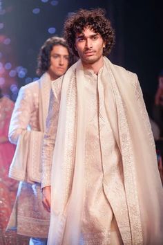 Ivory sherwani made in raw silk base with all over zari embroidery. Paired with an inner kurta and straight pant.
Components: 3
Pattern: Embroidery
Type Of Work: Zari
Neckline: Stand Collar
Sleeve Type: Full Sleeves
Fabric: Raw Silk
Color: Ivory
Other Details: 
Note: The stole worn by the model and the outfit worn by the model at the back is not for sale
Occasion: Groom,Wedding - Aza Fashions Ivory Sherwani, Raw Silk Embroidery, Ridhi Mehra, Anushree Reddy, Tarun Tahiliani, Vogue India, Drape Sleeves, Silk Embroidery, Wedding Groom