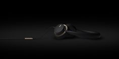 an image of two earphones connected to each other on a black background with gold accents