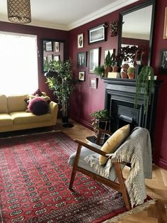 a living room filled with furniture and a red rug on the floor next to a fire place