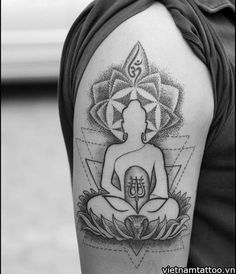 a person with a tattoo on their arm and sitting in the middle of a lotus