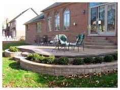 an outdoor patio with steps leading up to the house