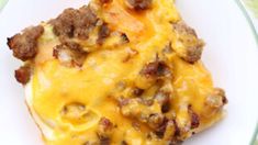 a white plate topped with meat and cheese covered casserole