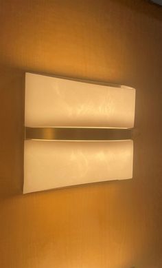 two light fixtures mounted on the wall in a room