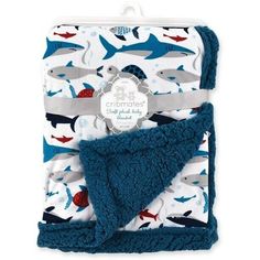 a blue and white blanket with shark print on the front, it's attached to a