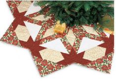 two quilted christmas tree mats on top of each other