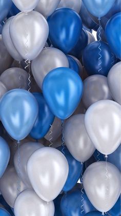 a bunch of balloons that are blue and white with some silver on the bottom one