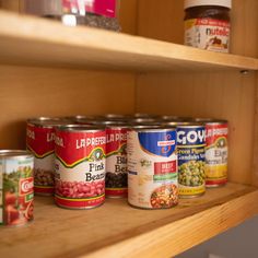 several cans of food are sitting on the shelves