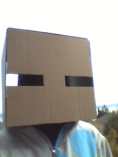 a person with a cardboard box on their head that looks like an evil looking face