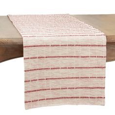 a red and white table runner on top of a wooden bench