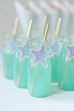 small jars with straws and starfish decorations on them