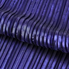 purple pleated velvet fabric textured with metallic foiling, close - up view