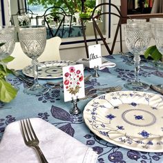 the table is set with place cards and silverware for guests to enjoy their meal