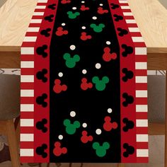 a mickey mouse table runner on top of a wooden table