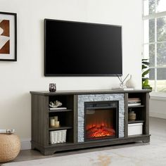 a living room with a fireplace and television on the wall in front of a large flat screen tv