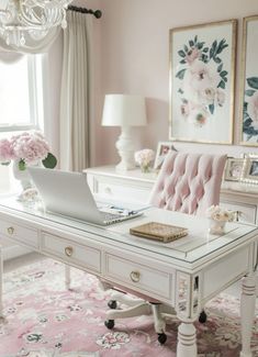 a white desk topped with a laptop computer sitting on top of a pink rug next to a window