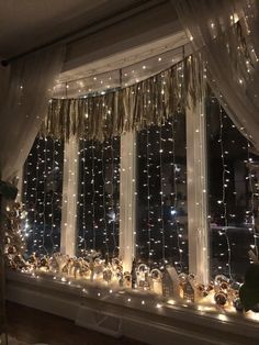 a window covered in lights and curtains