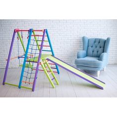 two children's swings and a chair in front of a brick wall with white bricks