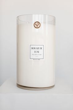 a white candle sitting on top of a table