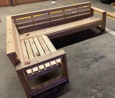 two wooden benches sitting next to each other in a parking lot with no one around them