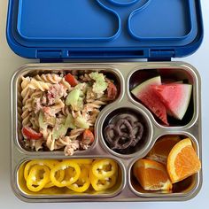 an open lunch box filled with pasta, fruit and veggies