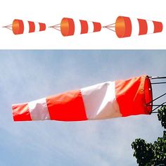 an orange and white striped kite flying in the sky