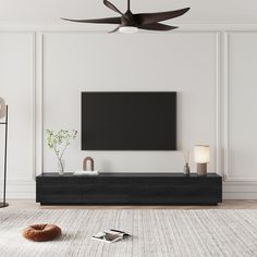 a flat screen tv mounted on the wall in a living room with white walls and flooring