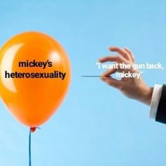 a person holding a balloon with the words mickey's hetrosexnality written on it