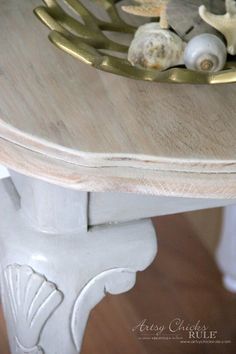 a close up of a table with seashells on it and gold trimming