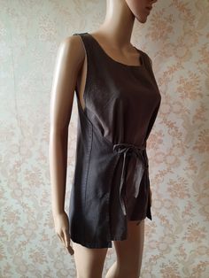 "Vintage wrap \\ tabard top \\ tunic in brown linen. This top wraps around the waist back and front so is a free size.  100% cotton\\linen it is very cool to wear in the summer.  It has a crew neck and ties at the front and back. Widest part;   64\" Length;  28\"      Made by Anitcha       50% cotton 50% linen" Fitted Linen Tunic For Summer, Fitted Lagenlook Tunic For Summer, Fitted Linen Top With Tie Waist, Fitted Linen Tops With Tie Waist, Fitted Brown Wrap Top, Sleeveless Brown Linen Top, Brown Sleeveless Linen Top, Fitted Bohemian Linen Tops, Wrap Tunic