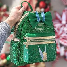 This backpack features emerald green sequins, metallic gold trim and gold-colored hardware, faux leather applique bow with organza wings, adjustable shoulder straps, a front zip pocket, 2 side pockets, and debossed and printed details. Cute Mini Backpacks, Sequin Backpack