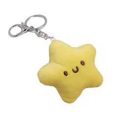 a yellow star shaped plush keychain with eyes on it's face and nose