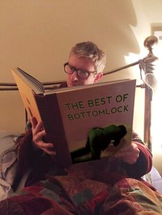 a man sitting in bed reading a book with the caption amanda abbington @ little light reading