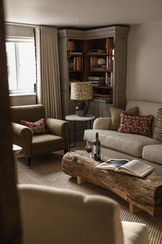 a living room filled with furniture and a book shelf