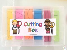 a plastic container filled with cut outs and scissors