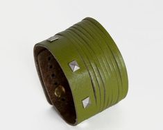 This studded leather cuff, in a beautiful lime green, is a great way to add some edge to your outfit.A leather and suede multi strand bracelet with adjustable metal stud closure. Metal details in either brushed steel or brushed gold plate.  Please specify metal finish upon ordering.Can also be worn with our Orchidea watch and is available in a variety of colours: https://www.etsy.com/shop/Rimanchik/search?search_query=orchidea&order=date_desc&view_type=gallery&ref=shop_searchFits wrists from 14. Lime Green Bracelet, Suede Bracelet, Multi Strand Bracelet, Strand Bracelet, Studded Leather, Brushed Steel, Handcrafted Leather, Leather Cuffs, Metal Bracelets