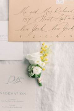 the wedding stationery is laid out on top of each other with flowers and calligraphy