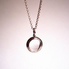 Handmade to order from sterling silver materials and set with a genuine, natural and watery clear quartz crystal ball. The sphere in this necklace measures 10mm in diameter with the bezel frame bringing the overall width to 13mm, approximately. After setting each stone, I bring the frame to a high glossy shine, and string them onto a 16-inch or 18-inch sterling silver rolo chain.The lore behind the pools of light jewelry went that each glowing crystal ball contained a tiny dancing spirit trapped Modern Open Circle Necklace For Formal Occasions, Modern White Gold Necklaces With Open Circle, Modern Circle Necklaces For Formal Occasions, Modern White Gold Necklace With Open Circle Design, Modern White Gold Open Circle Necklaces, Modern White Gold Open Circle Necklace, Glowing Crystal, Light Necklace, Light Jewelry