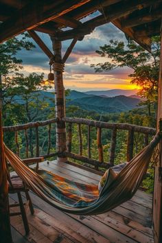 a hammock hanging from the side of a wooden porch