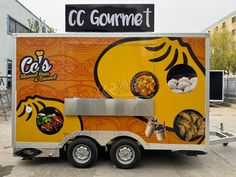 the food truck is decorated with an orange and yellow theme