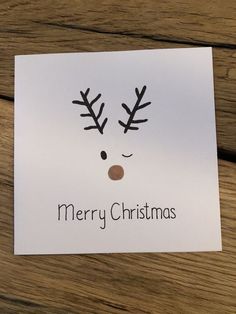 a christmas card with reindeer's nose and antlers on it