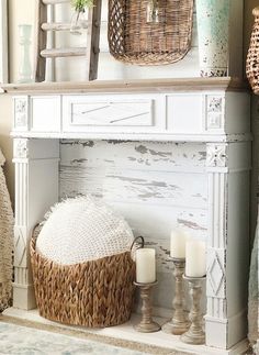 a white fireplace mantel with wicker baskets and candles